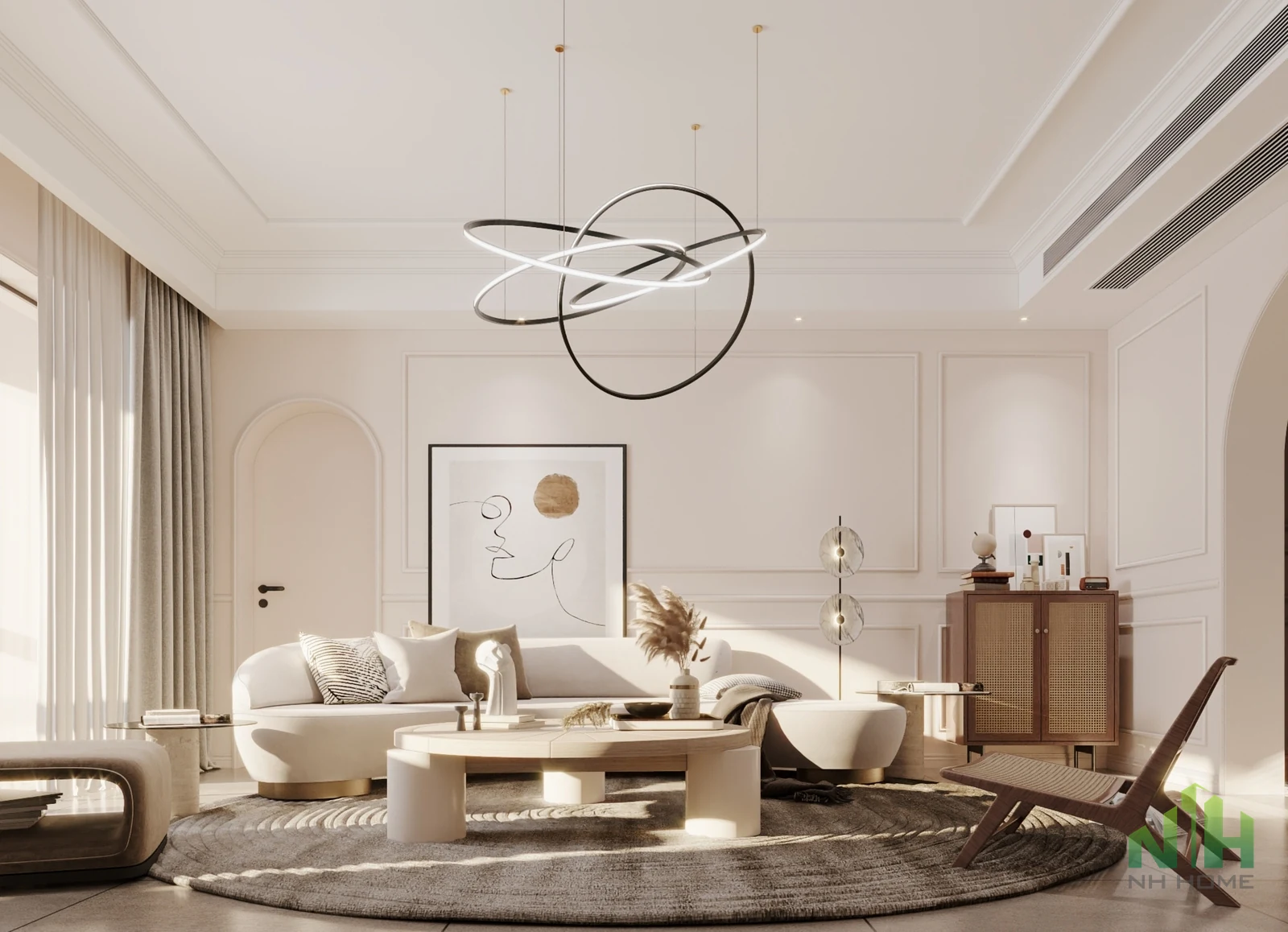 Phòng khách tông kem với sofa bo cong, bàn trà tròn, đèn thả vòng và tường phào chỉ.